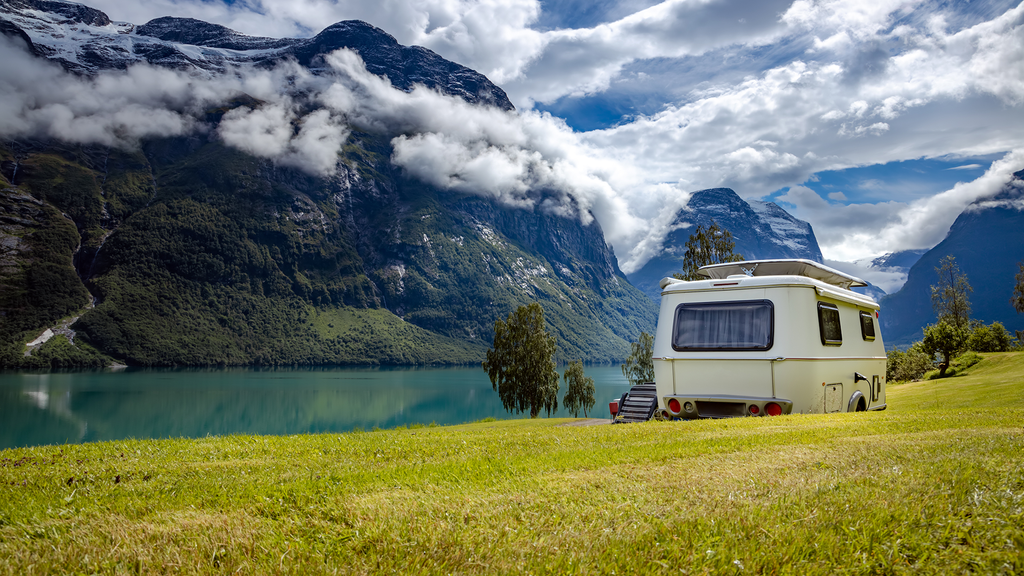 RV lifer in front of a lake 