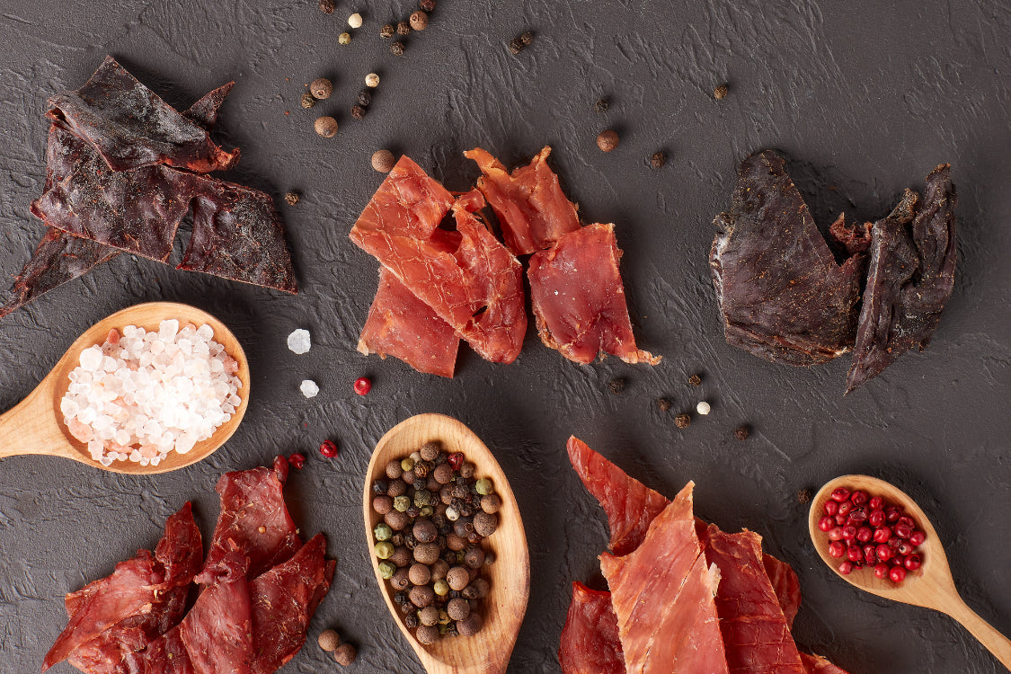 Variety of beef jerky types with sea salt and spices – showcasing different jerky flavor profiles and sodium levels.