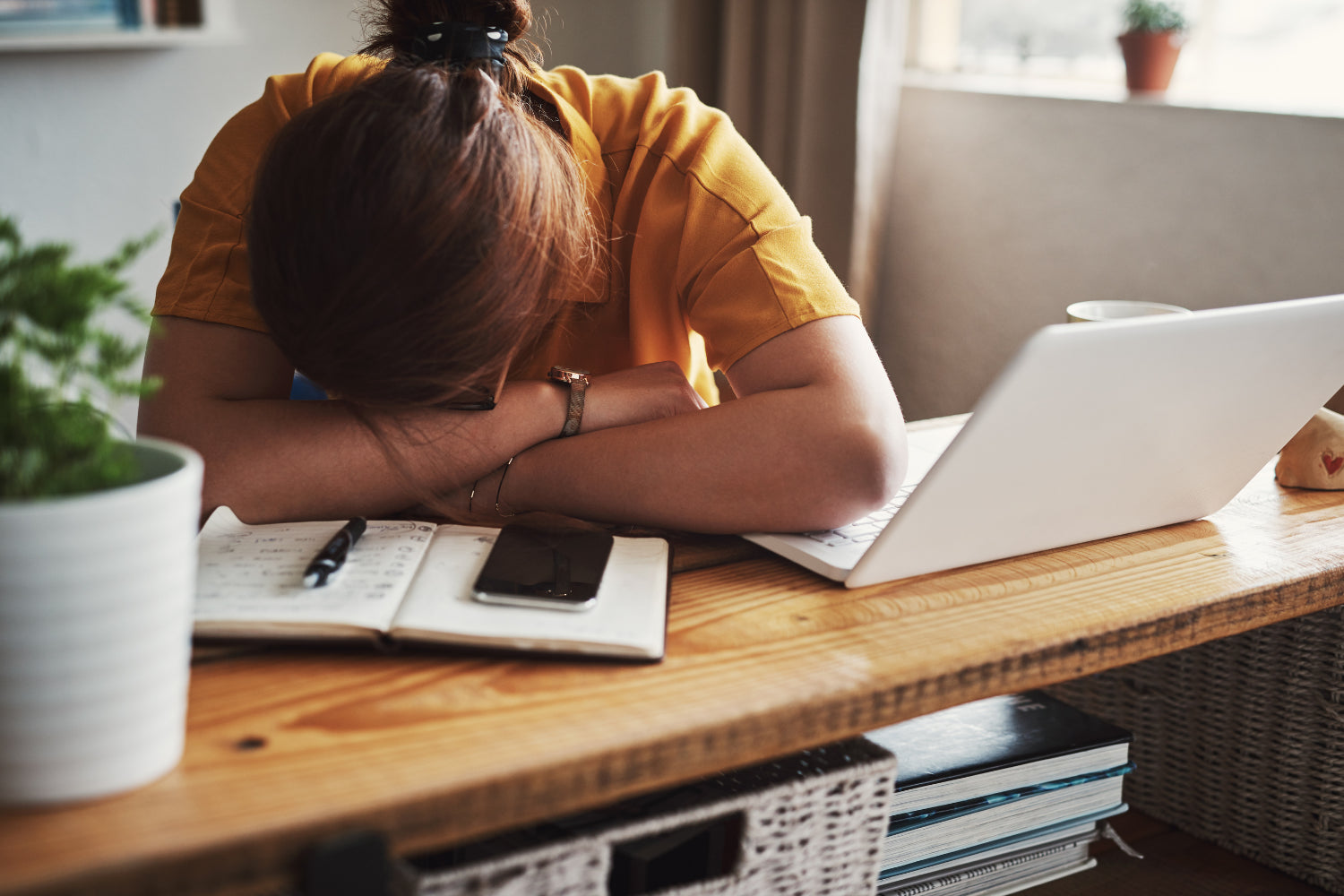 Woman taking a nap on her work desk.
