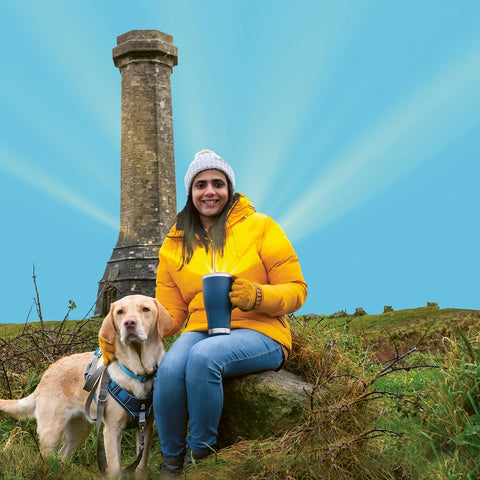 Dog walker by Hardy's monument with cup of Dorset Tea