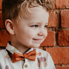 boy with light brown bow tie made from cork fabric