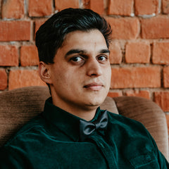 man wearing dark green shirt and black bow tie