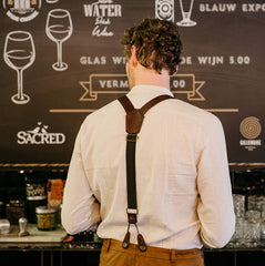 man wearing chocolate brown suspenders made from cork fabric