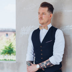 man wearing vest and wooden bow tie