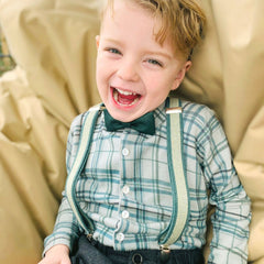 kid wearing green cork bow tie and suspenders