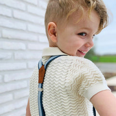 little boy wearing suspenders made from recycled jeans and cork fabric