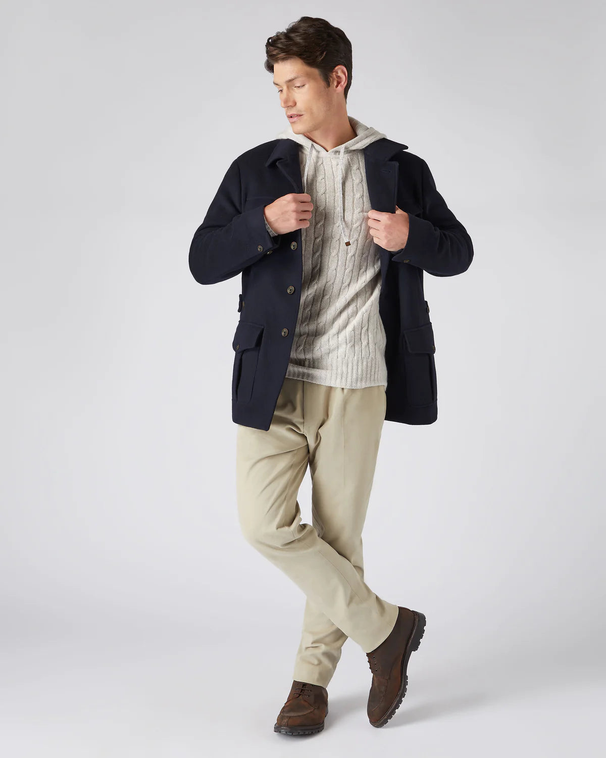 male wearing cashmere hoodie and coat with beige pants