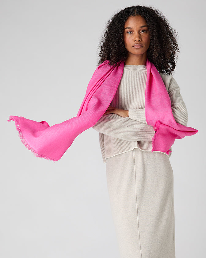 woman wearing bright pink shawl draped over shoulders