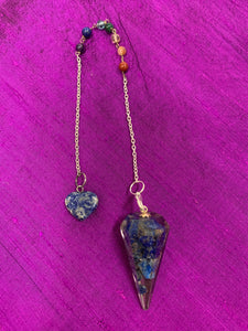 Orgonite pendulum with lapis, accented with 7 chakra gemstone beads, on the its chain, 1 for each of the 7 major chakras. Also accented by a lapis gemstone heart at the end of the the pendulum's chain.