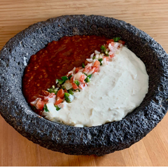 AlbaLisa Spicy Jalapeño Sauce (Red) and Jalapeño Cream Sauce (white) in a Molcajete