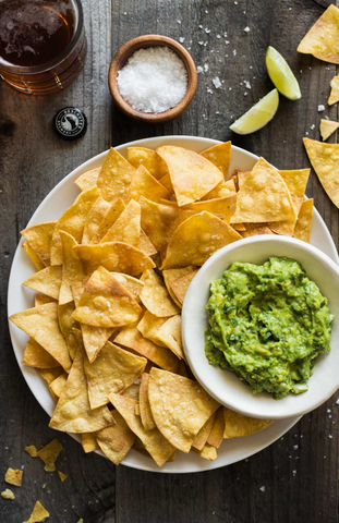 Tortilla Chips in a bowl with guacamole 