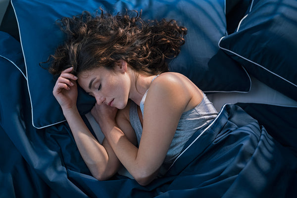 Person sleeping in bamboo bedding 