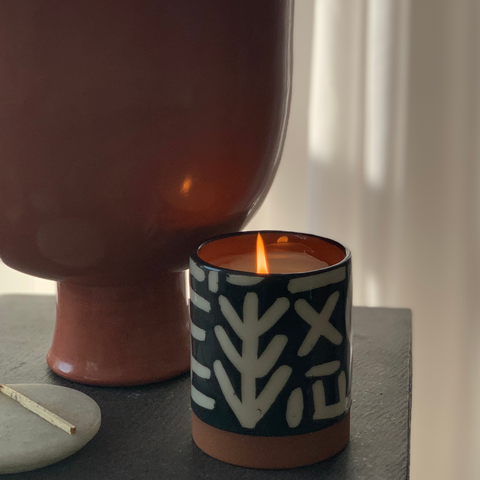 Scented candle with moroccan berber symbols in a warm setting