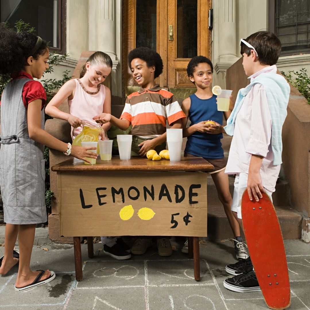 A group of young kids working hard with their new lemonade stand and taking their first steps into the world of entrepreneurship. The journey to entrepreneurship doesn't have to be with both feet. It can be fund and rewarding. Just like a lemonade stand!