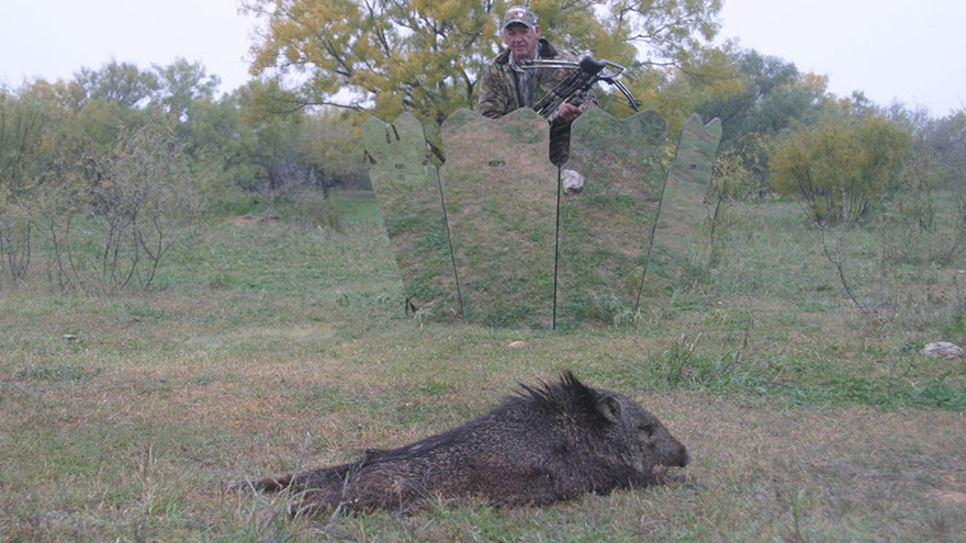 a hunter standing up from behind a mirrored ground blind