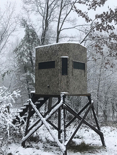 an elevated hunting blind in the snow