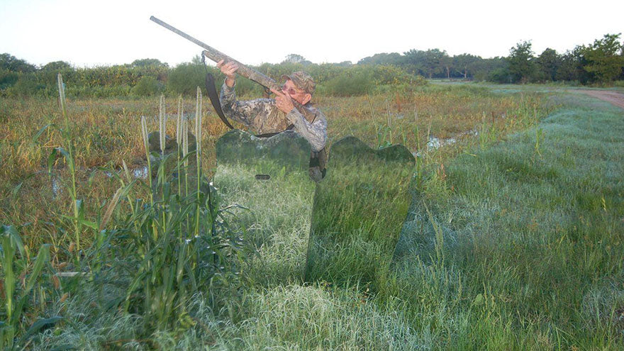 hunter behind camouflaged blind