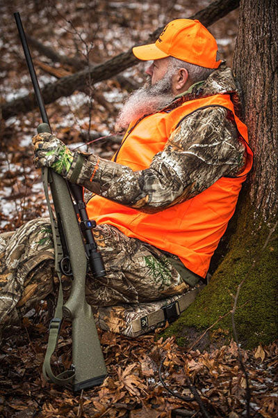 hunter sitting with shotgun