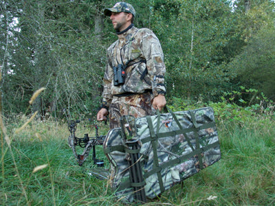 a man carrying a hunting blind