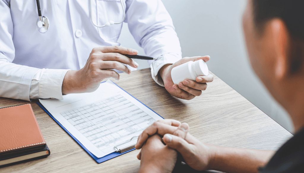 A man consulting his health practitioner about how to take his supplements