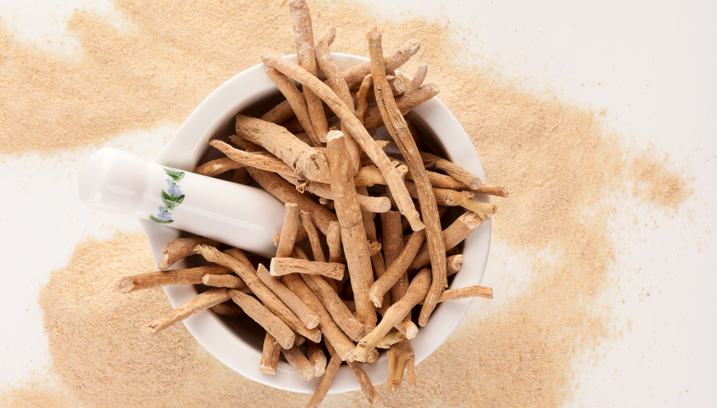 Ashwagandha roots in a brown bowl and ashwagandha powder in a white table