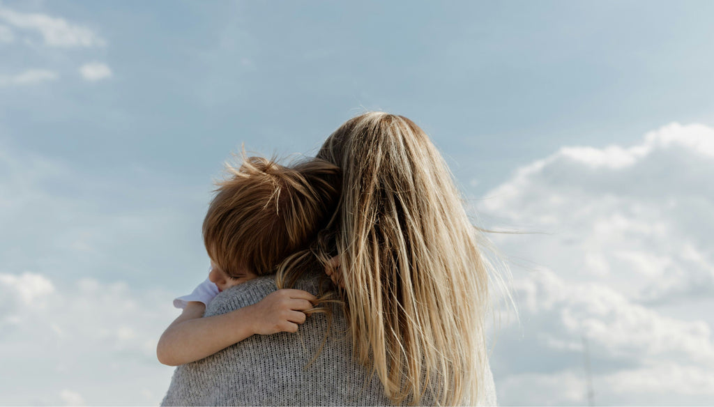 Mom holding her kid watching the sky