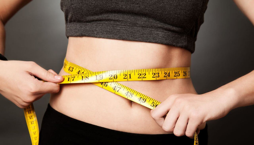 A woman holding a tape measure in her waist.