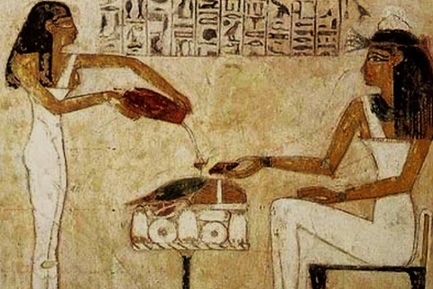 Egyptian hieroglyphics showing women pouring beer