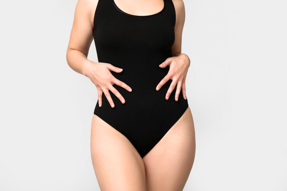 Mulher vestindo Fato de banho menstrual preto de uma peça só