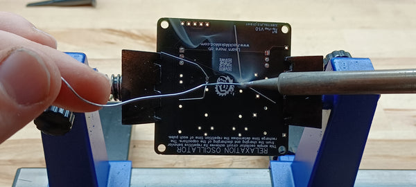 Soldering two capacitors from below