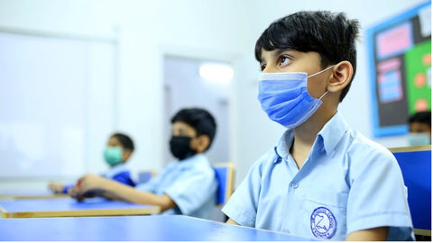 young children in classroom wearing face masks
