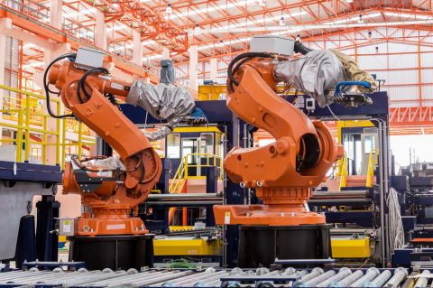 Welding robots in an industrial factory