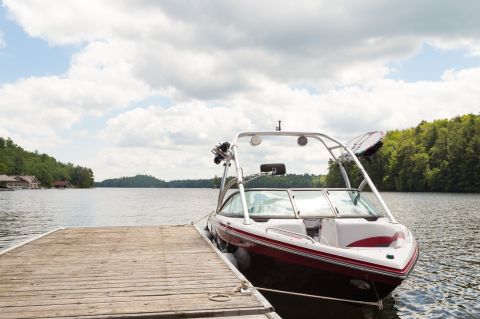 A small boat at a wooden dock 