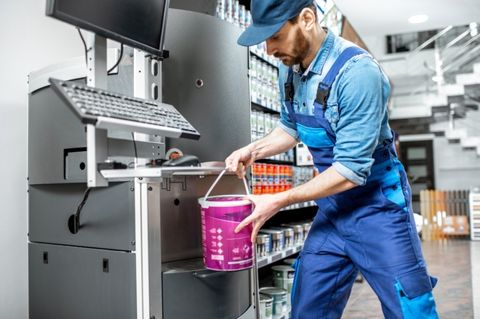 Man mixing paints with a shaker