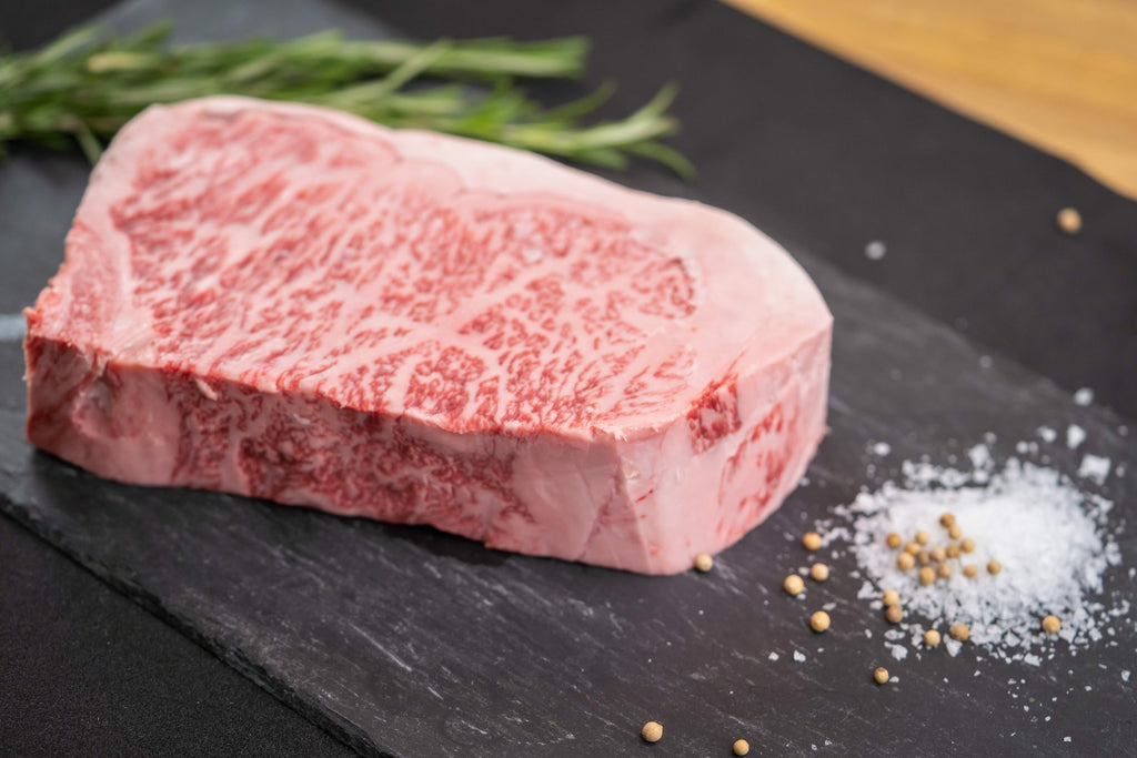 Picture of a Wagyu steak next to salt on a plate