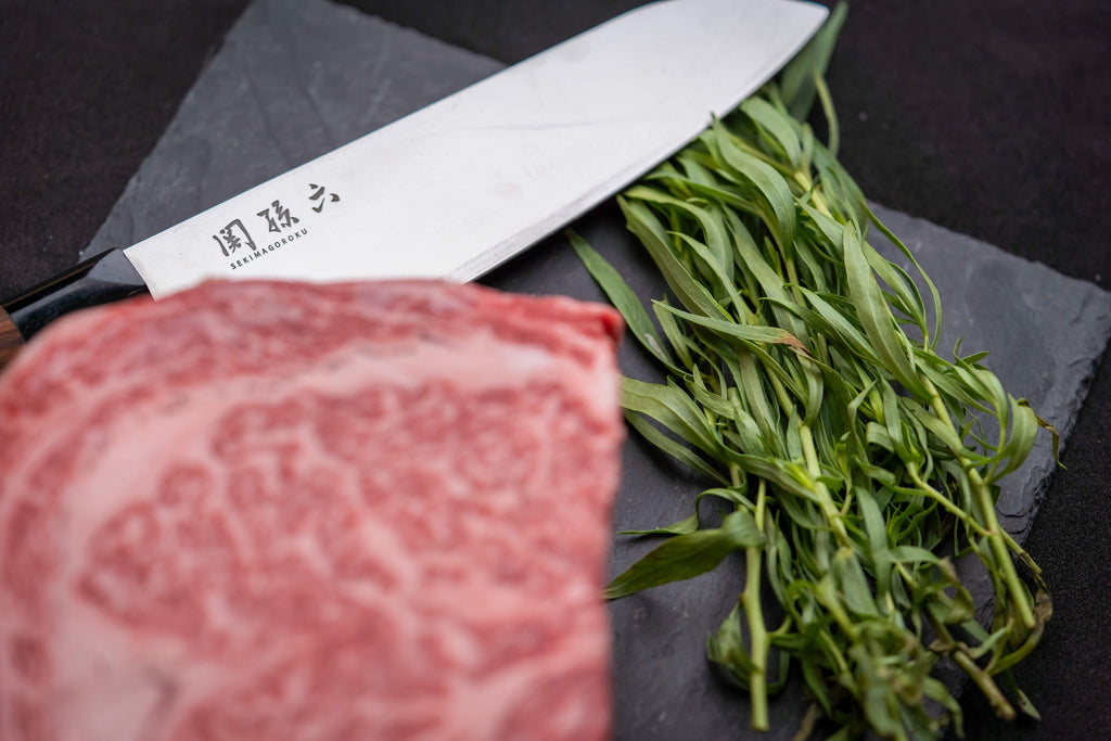 Picture of a Japanese knife next to a steak