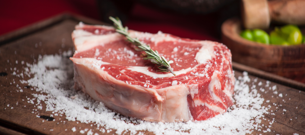 Picture of a ribeye steak with herbs and salt