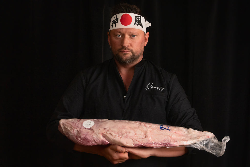 A chef holding a whole tenderloin