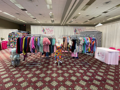 photo of britt and belle boutique's clothing booth and Tinsel and Treasures 2023 holiday shopping event
