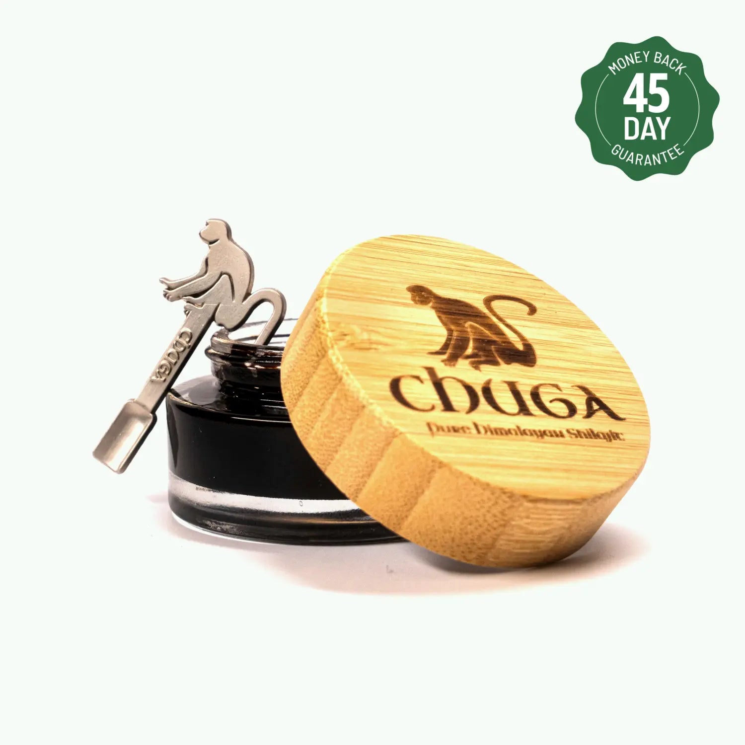 Ink bottle with wooden lid and metal dipper shaped like a monkey, with a '45 Day Money Back Guarantee' label.