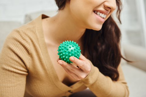 happy woman using massage ball