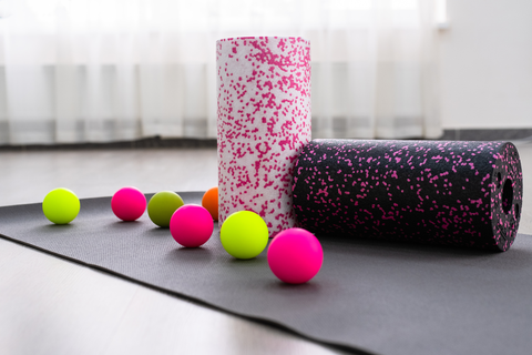 massage balls and yoga equipment on top of yoga mat