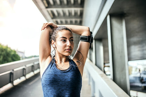 woman stretching arms post workout