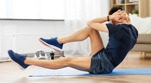 Man doing ab crunches on exercise mat at home