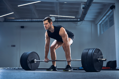 man in gym heavy weight lifting