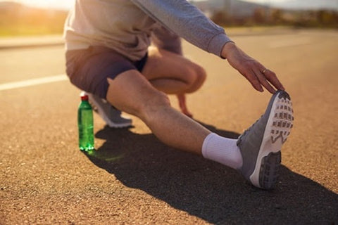 person stretching legs before going running