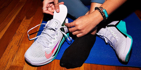 person tying laces on new running sneakers before jogging