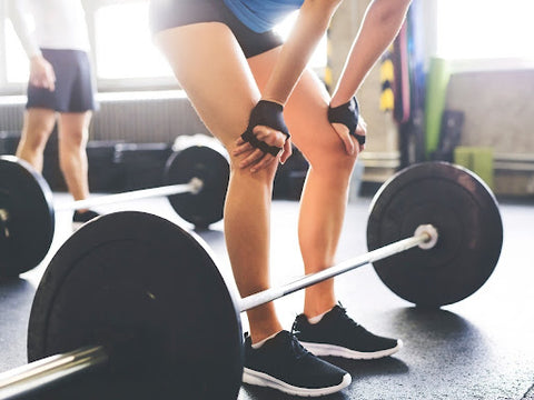 woman preparing to lift heavy weight at gym