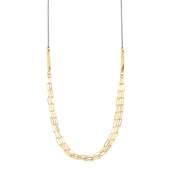 Close-up of black chain necklace with 3 delicate elongated link chains at the front.