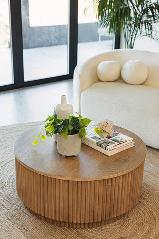 A modern living room featuring wavy wood furniture like the Lucca Reeded Coffee Table.